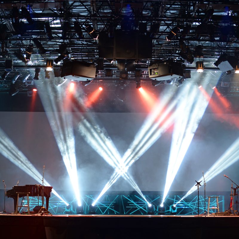 Concert lights on stage with assortment of musical instruments